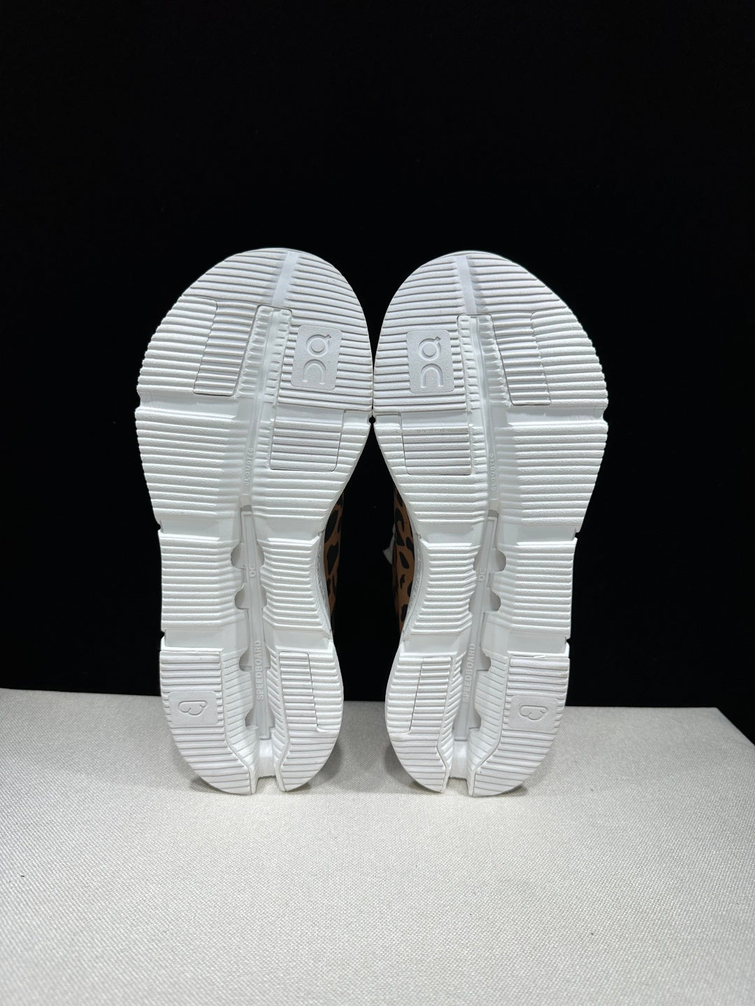 Leopard mesh sneaker with white laces and a grippy rubber outsole