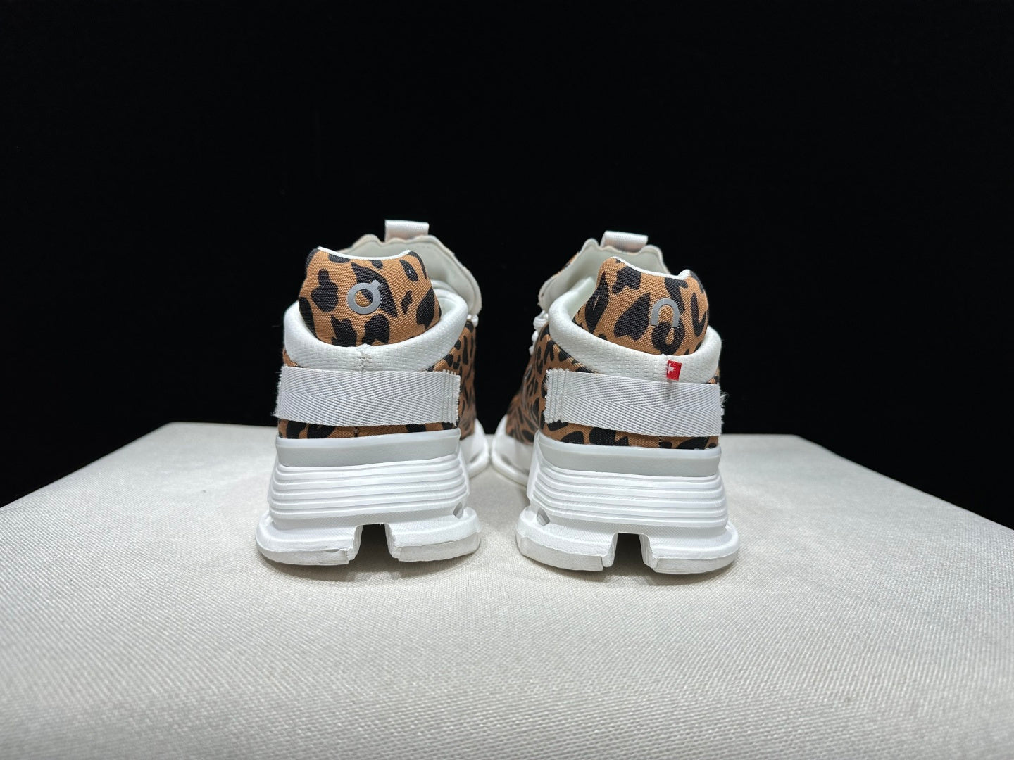Women's leopard-print sneaker showing the heel and low-top profile